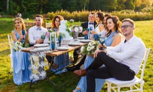 a couple and their wedding party taking photos