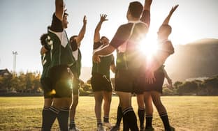 a soccer team high-fiving after a game